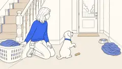A trainer watches a calm puppy whining with one paw raised toward the closed back door.
